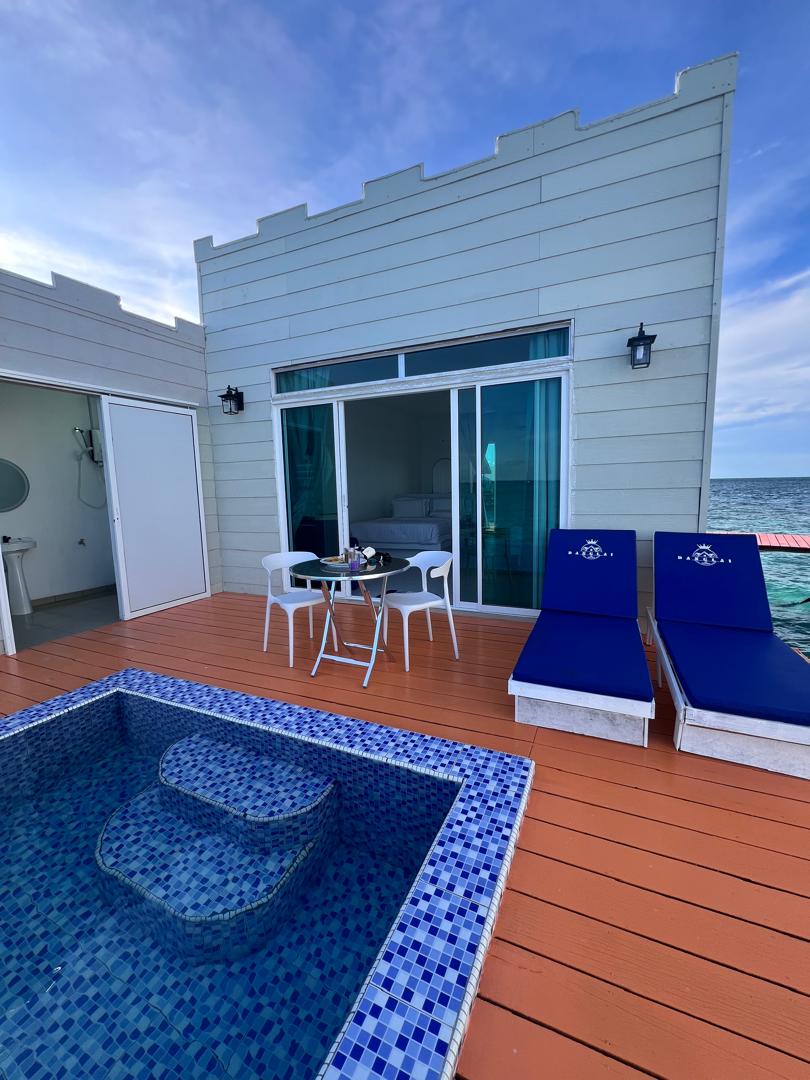 Outdoor deck with sun loungers and ocean view